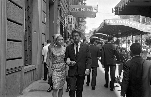 A charming man walking with a young woman along via Veneto nearby the Caf de Paris. Rome, 1960s (Photo by Marisa RastelliniMondadori via Getty Images)