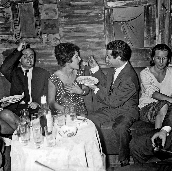 Italian actress Maria Fiore (Iolanda Di Fiori) eating spaghetti feeded by the Italian singer Armandino (Armando Zingone). Rome, 1960 (Photo by Reporters Associati & Archivi/Mondadori Portfolio via Getty Images)